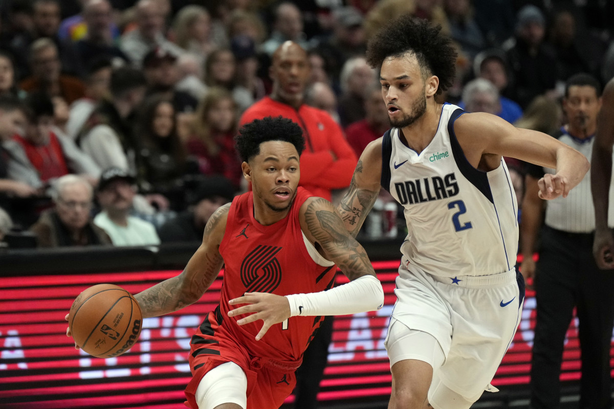 Mavs' Dereck Lively II defends Trail Blazers' Anfernee Simons on the drive.